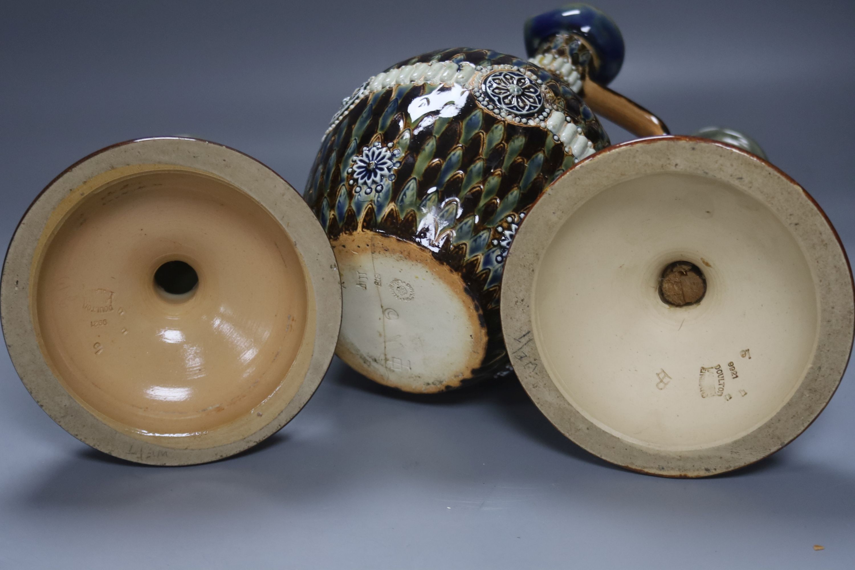 A pair of Doulton Lambeth stoneware candlesticks, height 30cm, and a similar 1878 ewer (cracked)